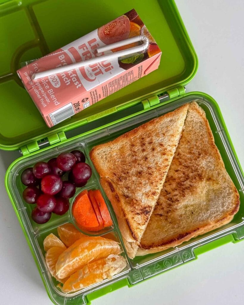 Bright Green Bento Box with Toasted Sandwich and Juice Box