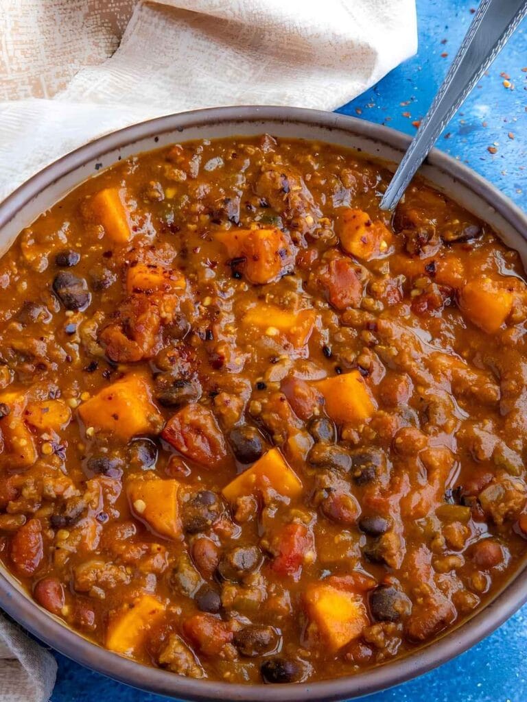 Trading traditional kidney beans and tomatoes for vibrant, tender chunks of sweet potato and black beans gives this chili a subtle, earthy sweetness that perfectly balances the spicy, savory ground beef broth.